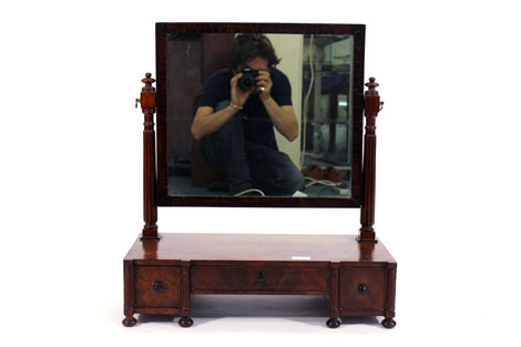A 19th century mahogany dressing table mirror, the rectangular plate over three drawers on bun feet,
