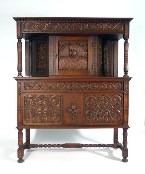 An early 20th century Continental carved oak court cupboard, dated 1603,