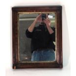 A 19th century wall mirror, the rectangular plate within a mahogany and giltwood frame,