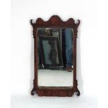 A George II-type wall mirror in a rosewood and gilt plaster frame of typical form,