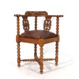 A reproduction 17th century-type carved oak corner chair with bobbin supports and a drop-in seat