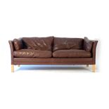 A 1970's Danish brown two-seater sofa on beech square legs CONDITION REPORT: