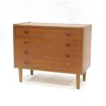 A 1960's teak chest of four long drawers on circular feet, w.