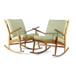 A pair of beech framed rocking chairs with loose cushions and sleigh runners by Scandart