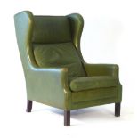 A 1970's green leather wingback armchair on mahogany square legs CONDITION REPORT: