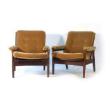 A pair of 1970's stained beech and button upholstered lounge armchairs CONDITION