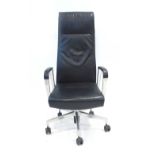 A contemporary black leather highback office armchair on a five star swivel base with castors