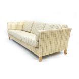 A 1970's striped fabric three seater sofa on oak square straight legs