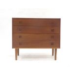 A 1960's Danish teak chest of four long drawers with turned handles on circular feet, w.