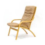 A 1970's beech and tan leather upholstered armchair