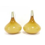 A pair of 1960's ceiling lights with mustard glass pendant shades