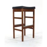 A 1970's teak and black vinyl stool