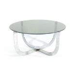 A 1970's circular coffee table, the glass surface resting on a chromed frame, d.