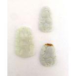 Three pale green jade pendants having carved decoration, max l.