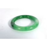 A green jade bangle, internal d. 5.