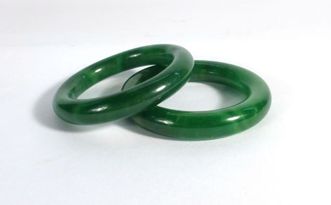 Two green jade bangles,