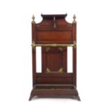 A late 19th century mahogany and brass mounted four compartment umbrella and stick stand attributed