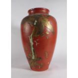 A Japanese vase of ovoid form, relief and gilt decorated with an eagle on a red ground,