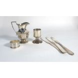 A silver cream jug of canted form, a silver napkin ring and a silver egg cup,