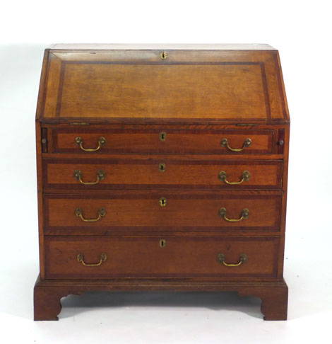 A George III oak and crossbanded bureau,