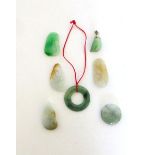 Seven pale green jade pendants of seed and circular form, max l. 3.