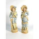 A pair of Continental bisque figures modelled as a dandy and his female companion, max h. 32.