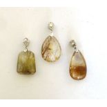 Three rutilated quartz-type pendants, max l. 4.