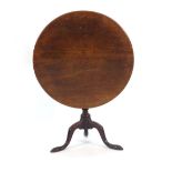 A George III mahogany tilt-top table on a turned column and tripod base, d.