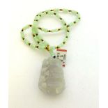 A pale green jade vertebrae bead necklace suspending a seed shaped pendant, pendant l. 5.