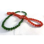 A green jade bead necklace and a similar orange coloured example (2)