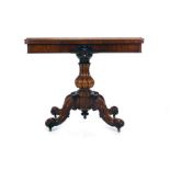 A Victorian figured walnut card table with a moulded apron on a bulbous column and four splayed