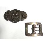 A metalware buckle centrally depicting a geisha in traditional dress, w. 8.