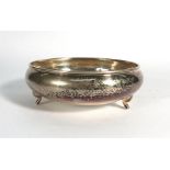 A German hammered metalware bowl of plain circular form on three outswept feet, d. 16 cm, 5.