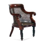 A 19th century mahogany and bergere children's armchair on turned front legs CONDITION