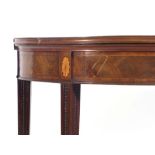 A George III mahogany, crossbanded and inlaid demi-lune card table on square tapering legs, w.