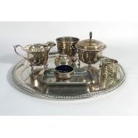 A mixed group of silver plated items including a pair of candlesticks, a circular tray,