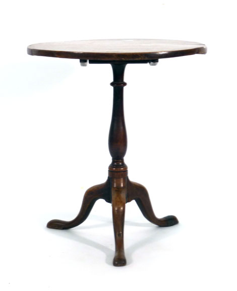 A George III elm tilt-top table, the circular top over a turned column and tripod base, d.