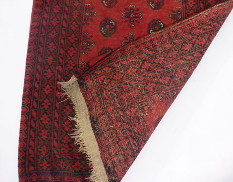 A late 19th century Turkoman-type rug, the red ground with medallions within matching borders, - Image 2 of 2