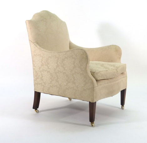 A George III-style upholstered highback armchair on mahogany square tapering legs