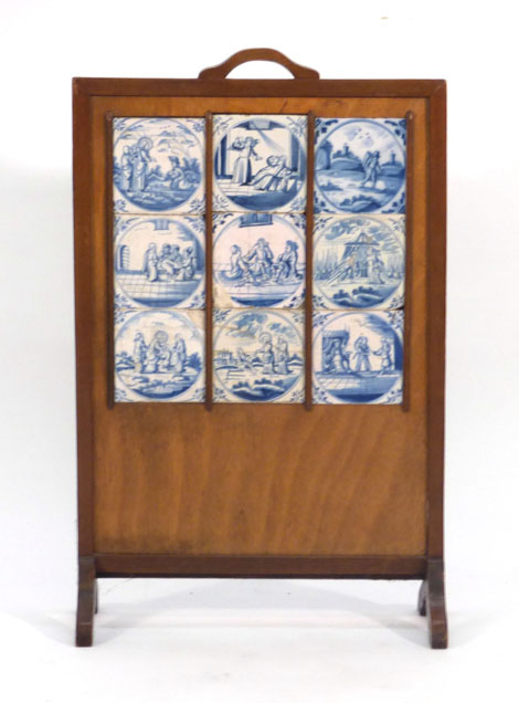 A 1920's oak firescreen inset with nine Delft tiles CONDITION REPORT: Damage to