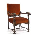 A 17th century-type carved oak and upholstered armchair with bulbous supports and a shaped