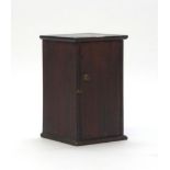 A 19th century single door cabinet with a partially fitted interior, h.