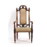 A late 19th century mahogany and upholstered high-back hall armchair on turned legs