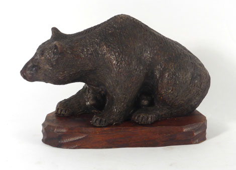 An early 20th century terracotta figure modelled as a bear with cubs,