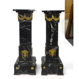 A pair of 'Noir du sable' marble jardiniere stands with gilt metal swags, h.