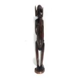 An early 20th century carved hardwood African figure modelled as a figure and parasitic worms, h.