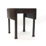 An early 19th century mahogany drop-leaf breakfast table with a single frieze drawer on canted legs,