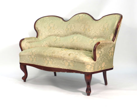 A 19th century mahogany two seater sofa with later upholstery on turned front legs