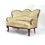 A 19th century mahogany two seater sofa with later upholstery on turned front legs