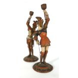 A pair of overpainted spelter figural candlesticks modelled as soldiers, h.